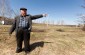 Mykhailo V., born in 1935, points out the field where the Jews were taken to graze. They were forced to kneel down and eat grass as if they were cattle, as Germans guarded them. ©Victoria Bahr/Yahad-In Unum